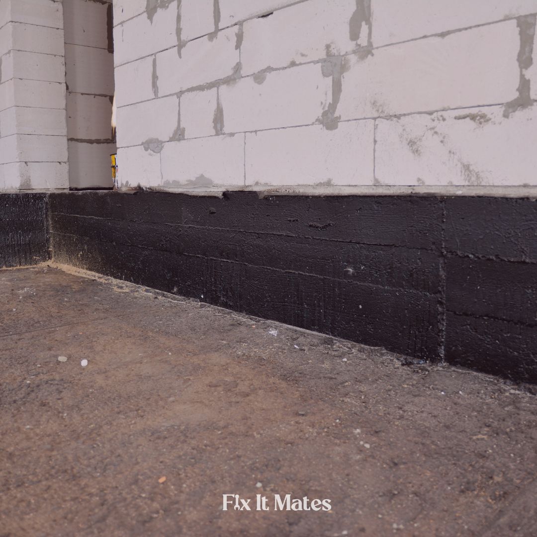 Basement waterproofing installation by Fix It Mates, showcasing a protective membrane applied to the walls and floor to prevent water seepage and moisture damage.