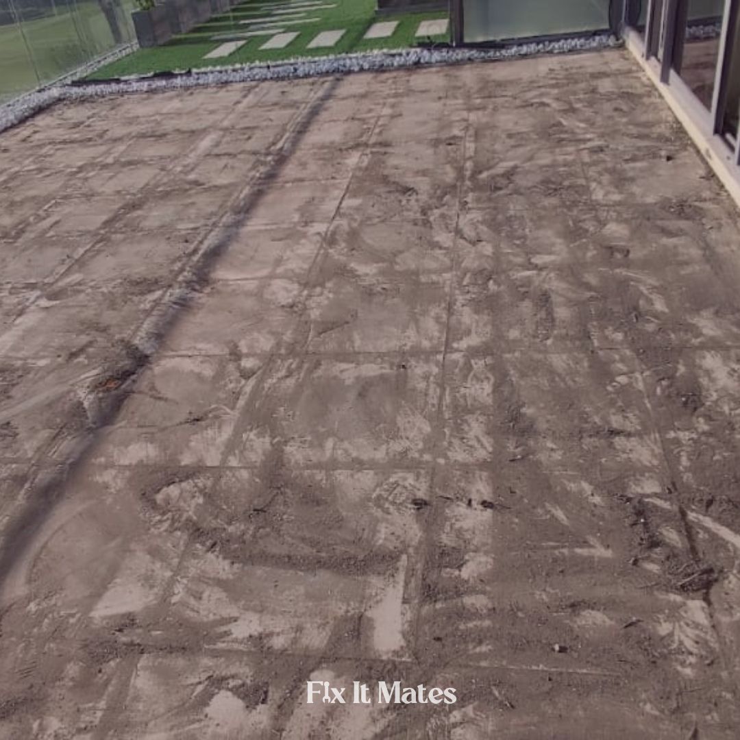 Fix It Mates technician performing cleaning and maintenance on a roof waterproofing system, ensuring optimal performance and longevity by removing debris and inspecting for any damage