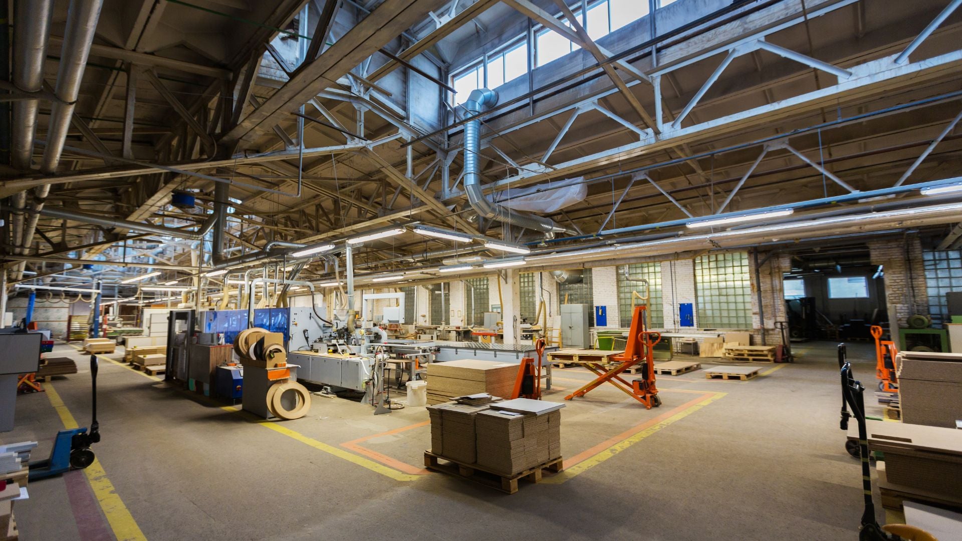 A view of the Fix It Mates joinery workshop, showcasing neatly arranged wooden planks, high-quality tools, and machinery used for crafting custom woodwork projects.